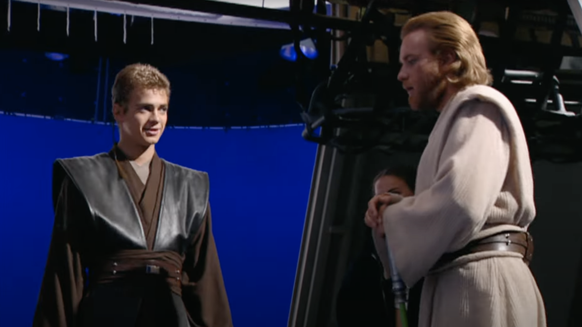 Two actors in Jedi robes stand in front of a blue screen.
