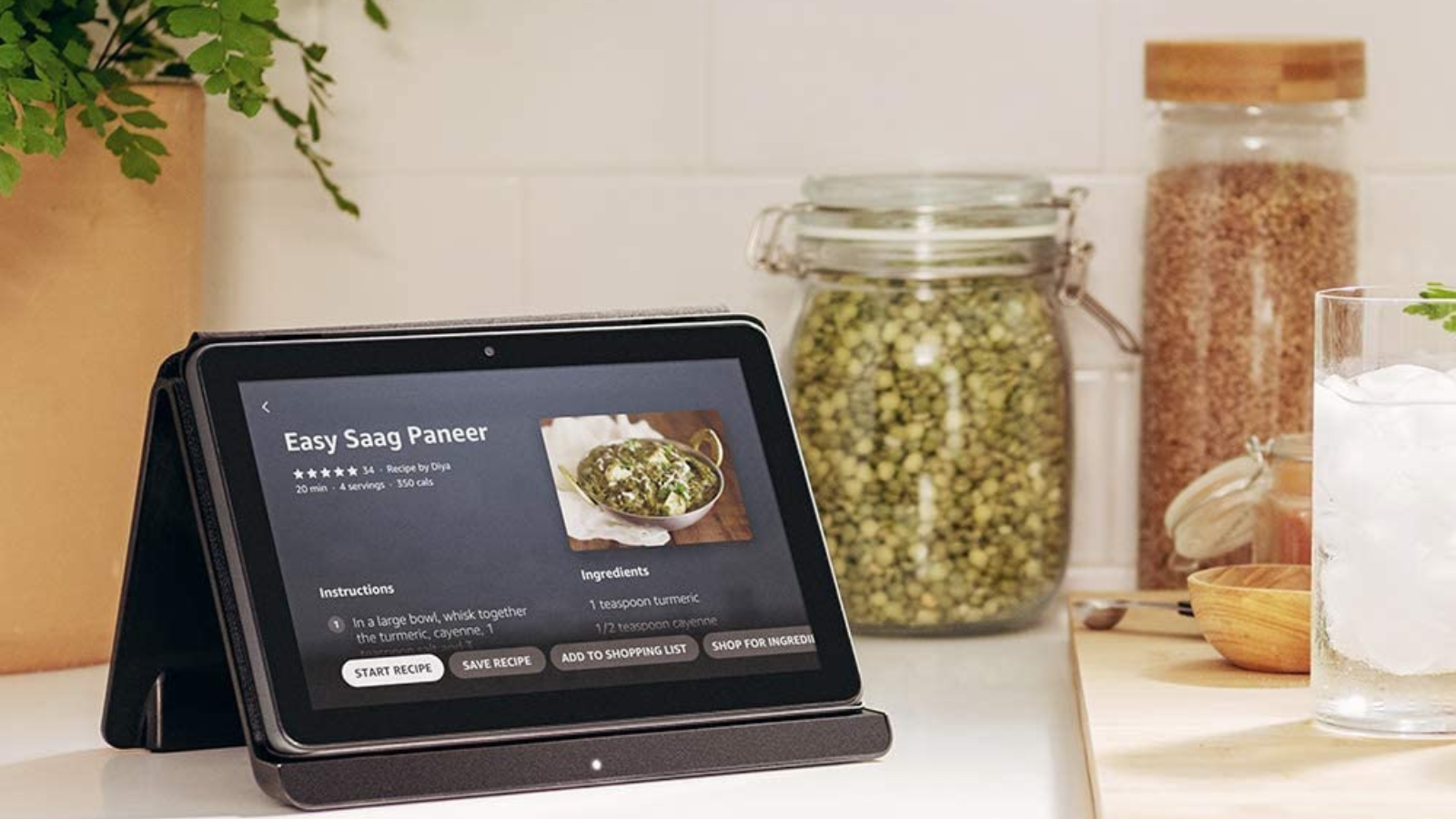 amazon fire hd 8 plus tablet sitting on kitchen counter next to jars of spices
