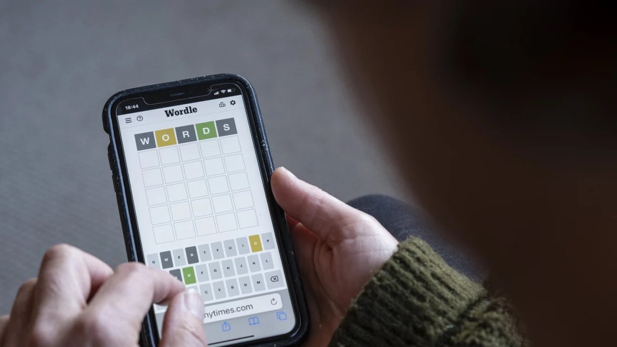 A person playing Wordle on their phone.