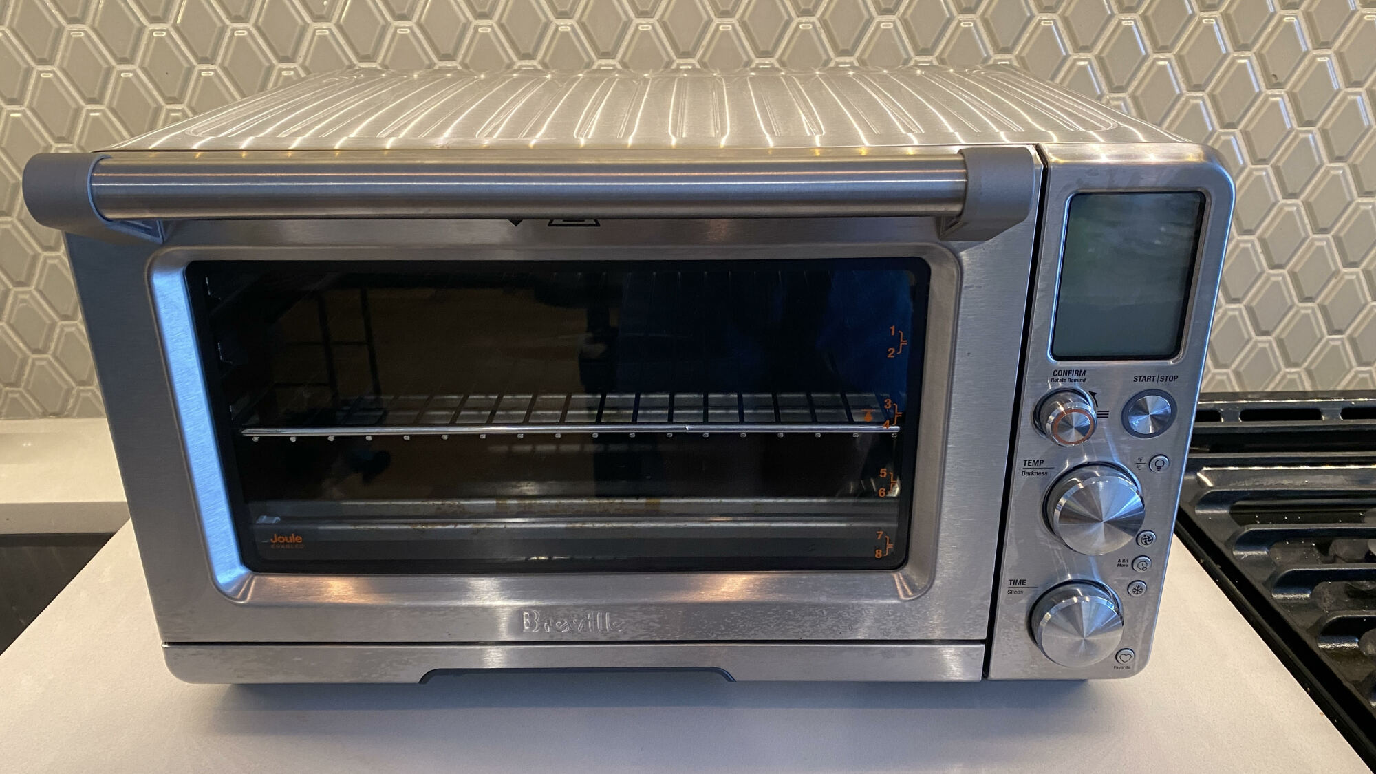 Silver toaster oven air fryer on a kitchen counter