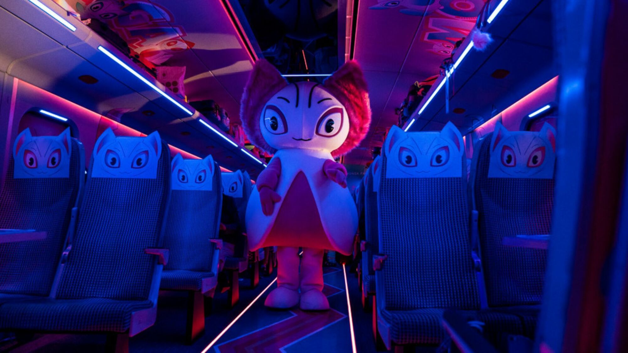 A anime figure costume stands on a train. 