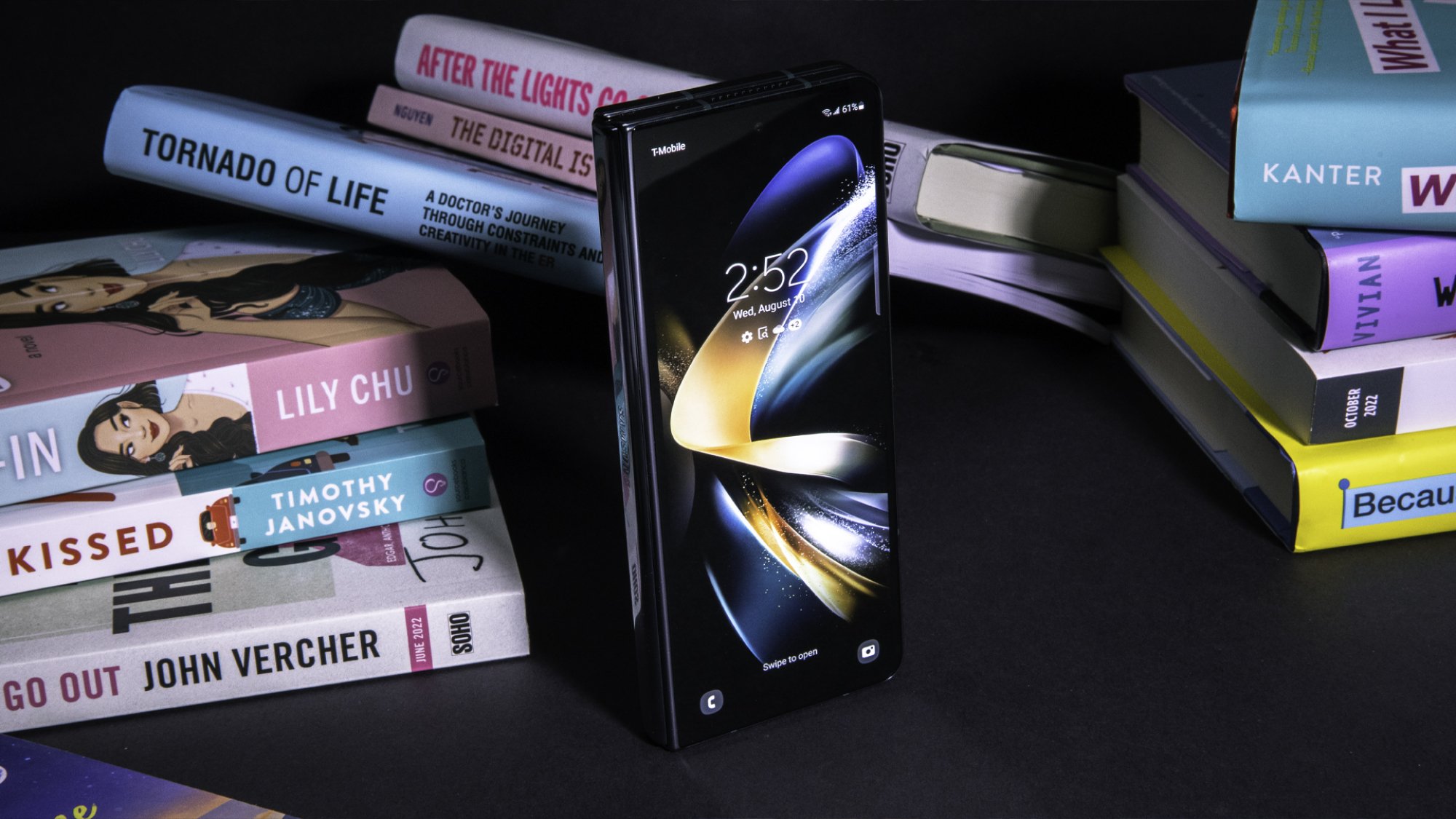 Samsung Galaxy Z Fold 4 propped up next to books with its folding display closed