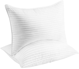 two beckham hotel collection pillows in white stacked on top of eachother