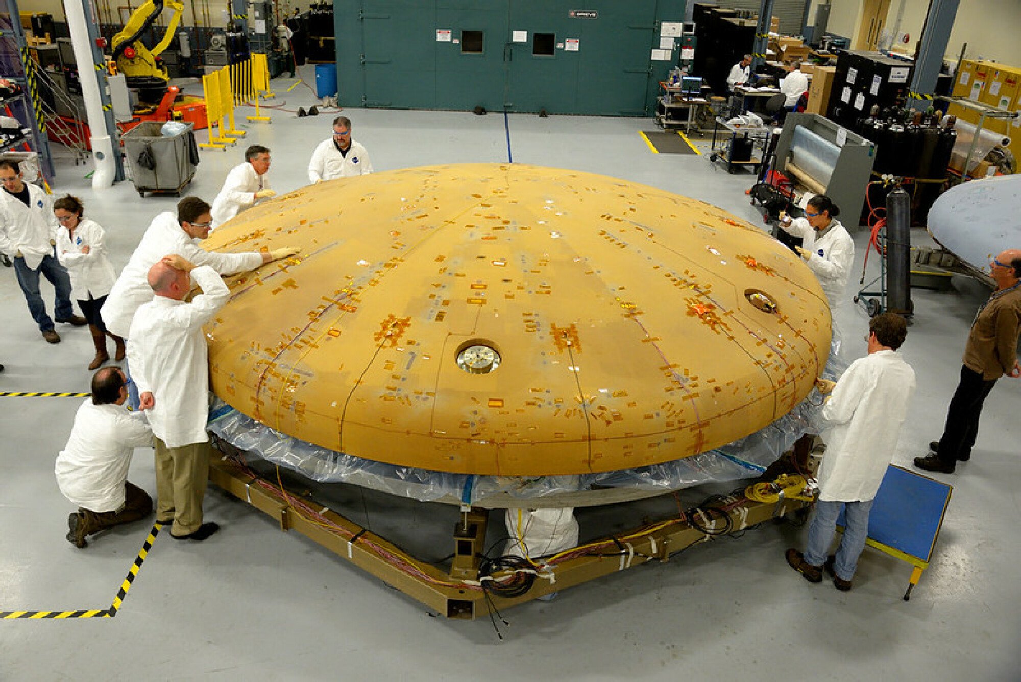 Engineers examining Orion's heat shield