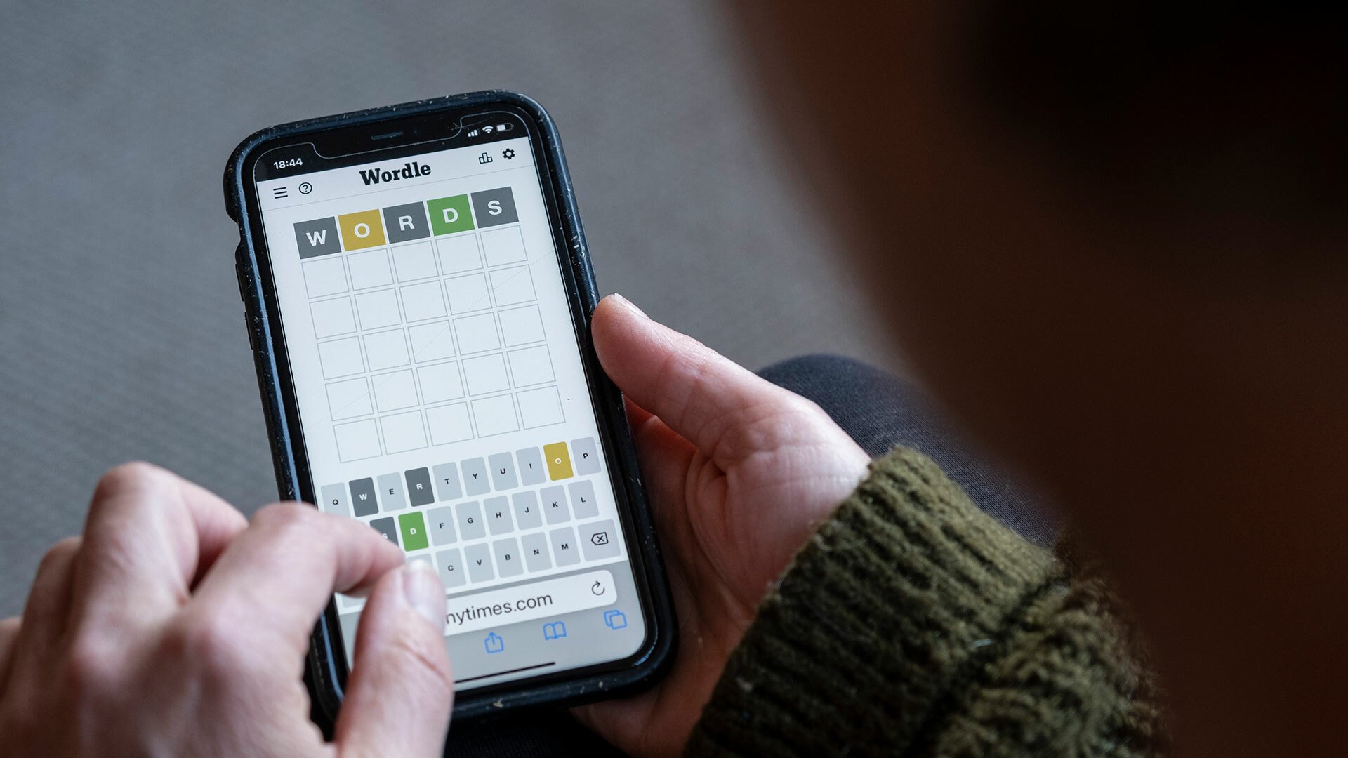 A close-up of someone playing Wordle on a smartphone.
