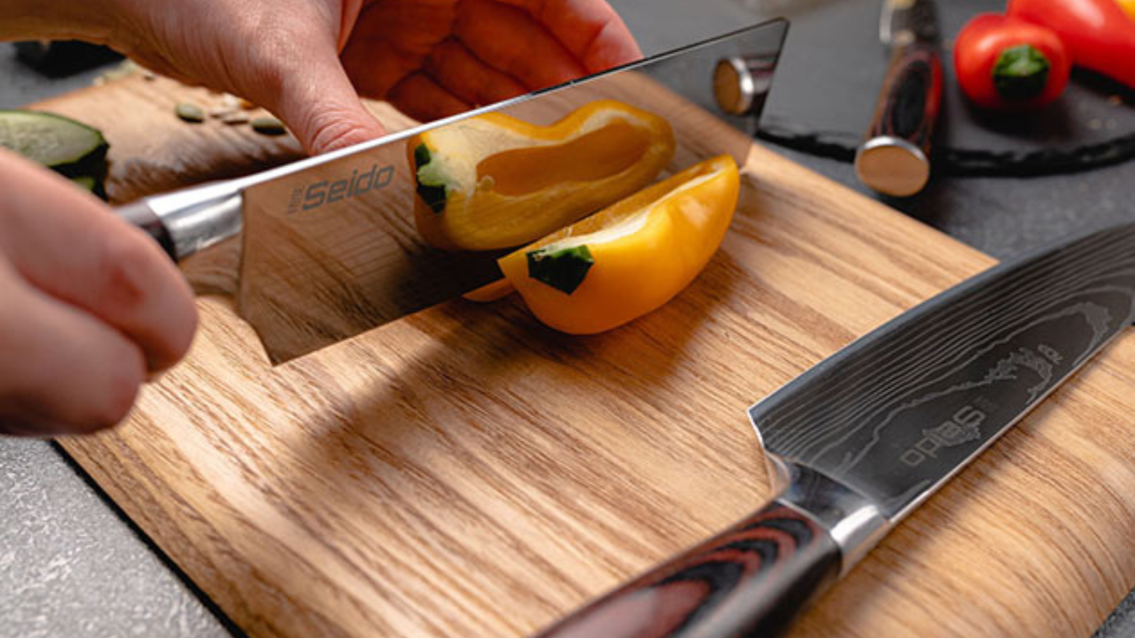 hand using seido japanese chef knives to chop vegetables on cutting board