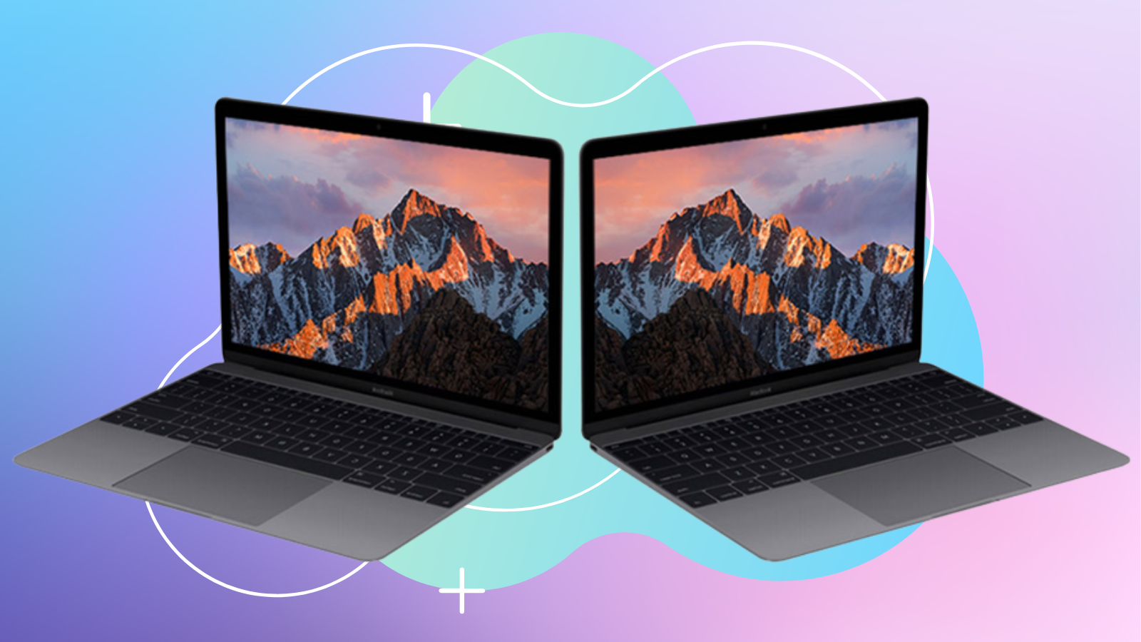 two 2017 macbooks with screens open facing the opposite directions against blue and pink background