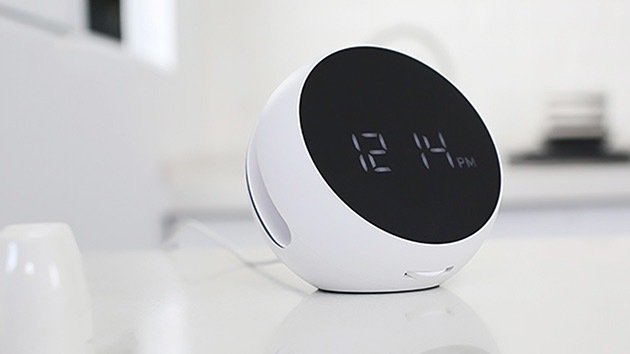 Desktop Wireless Charger with Alarm Clock on a table.