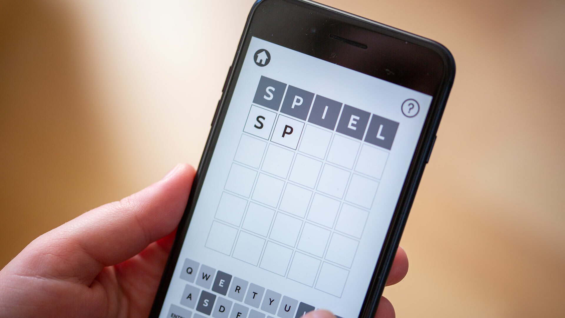 A close-up of someone playing Wordle on a smartphone.