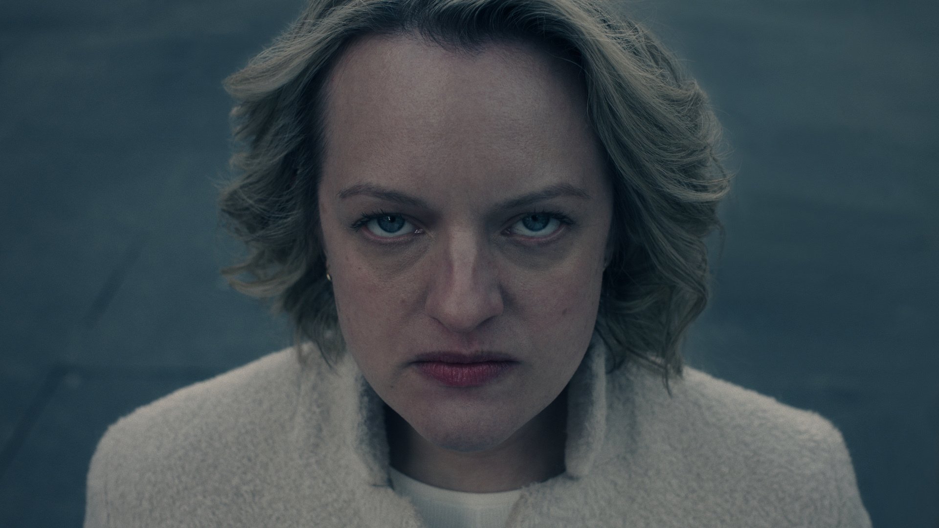 A woman looks directly into the camera looking furious.