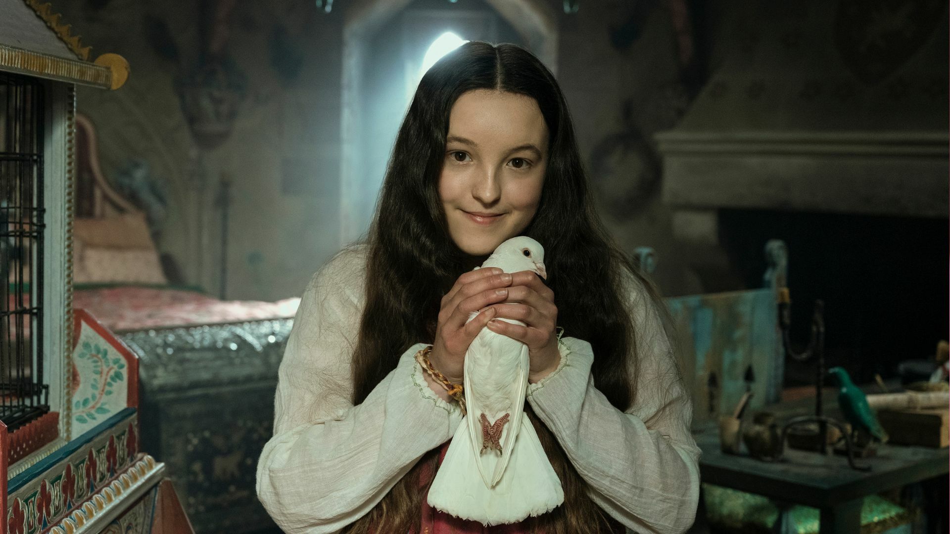 Bella Ramsey holds a bird as