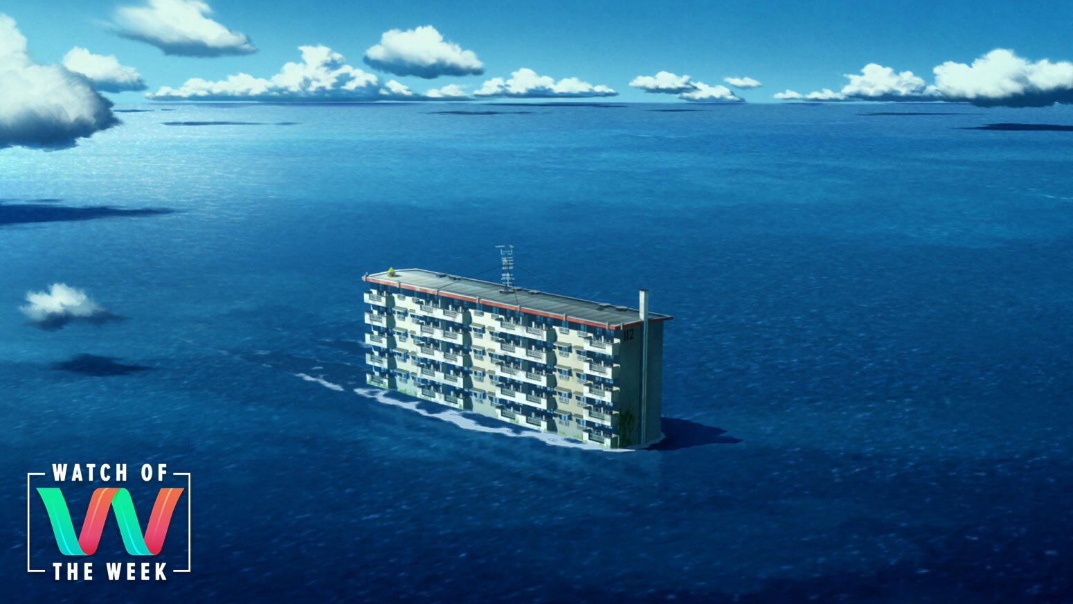 A building floats through the ocean.