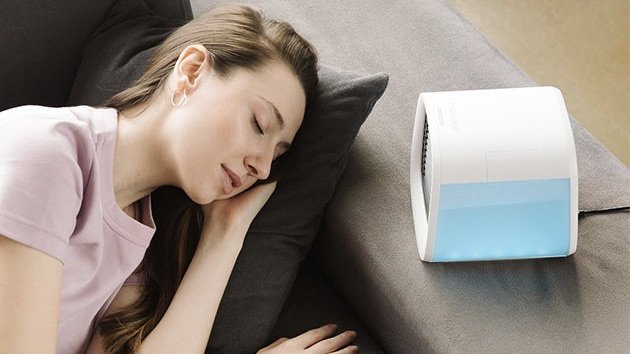 Person sleeping next to a EvaChill EV-500 Personal Air Conditioner.