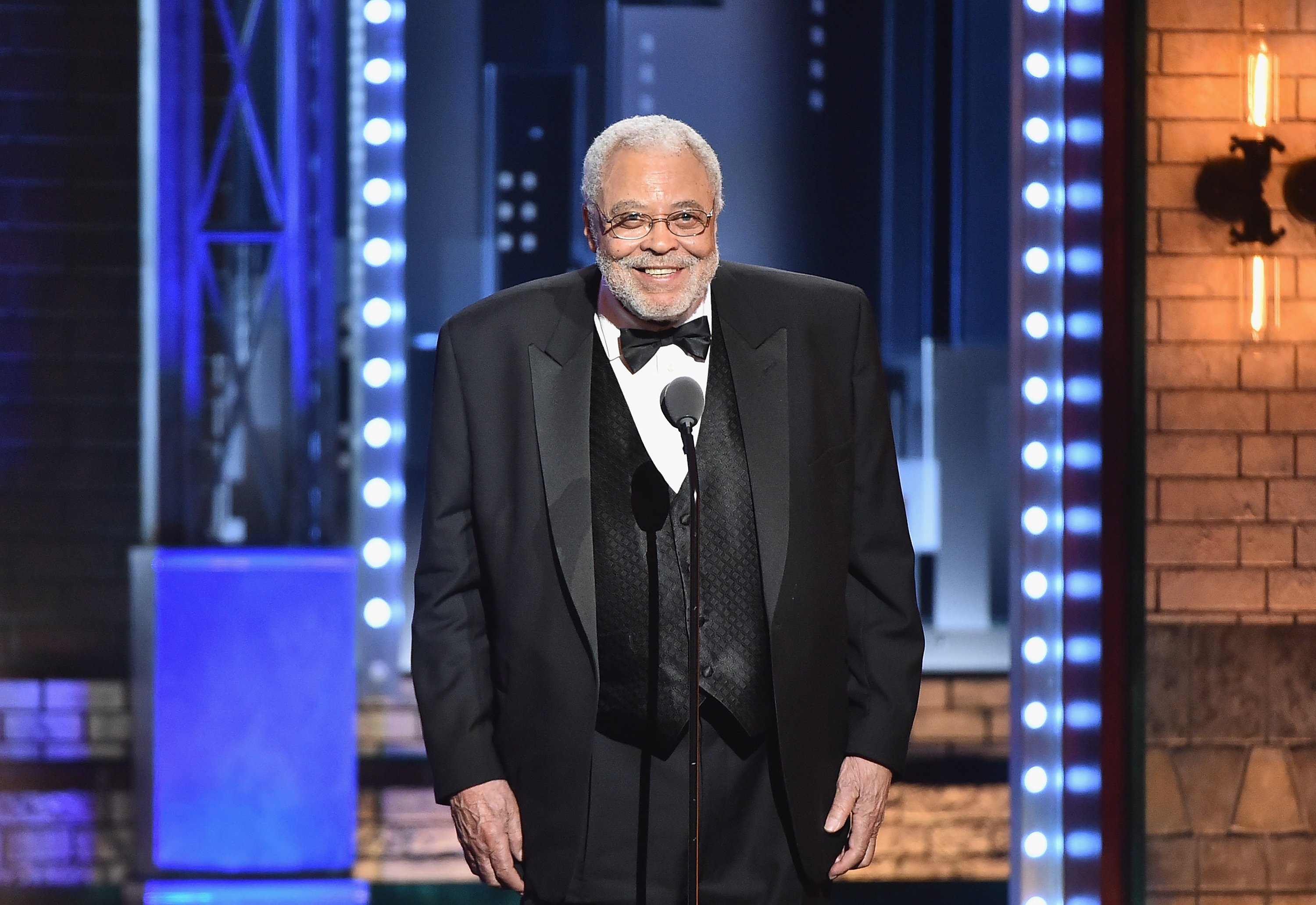 James Earl Jones in a tuxedo on stage accepting an award