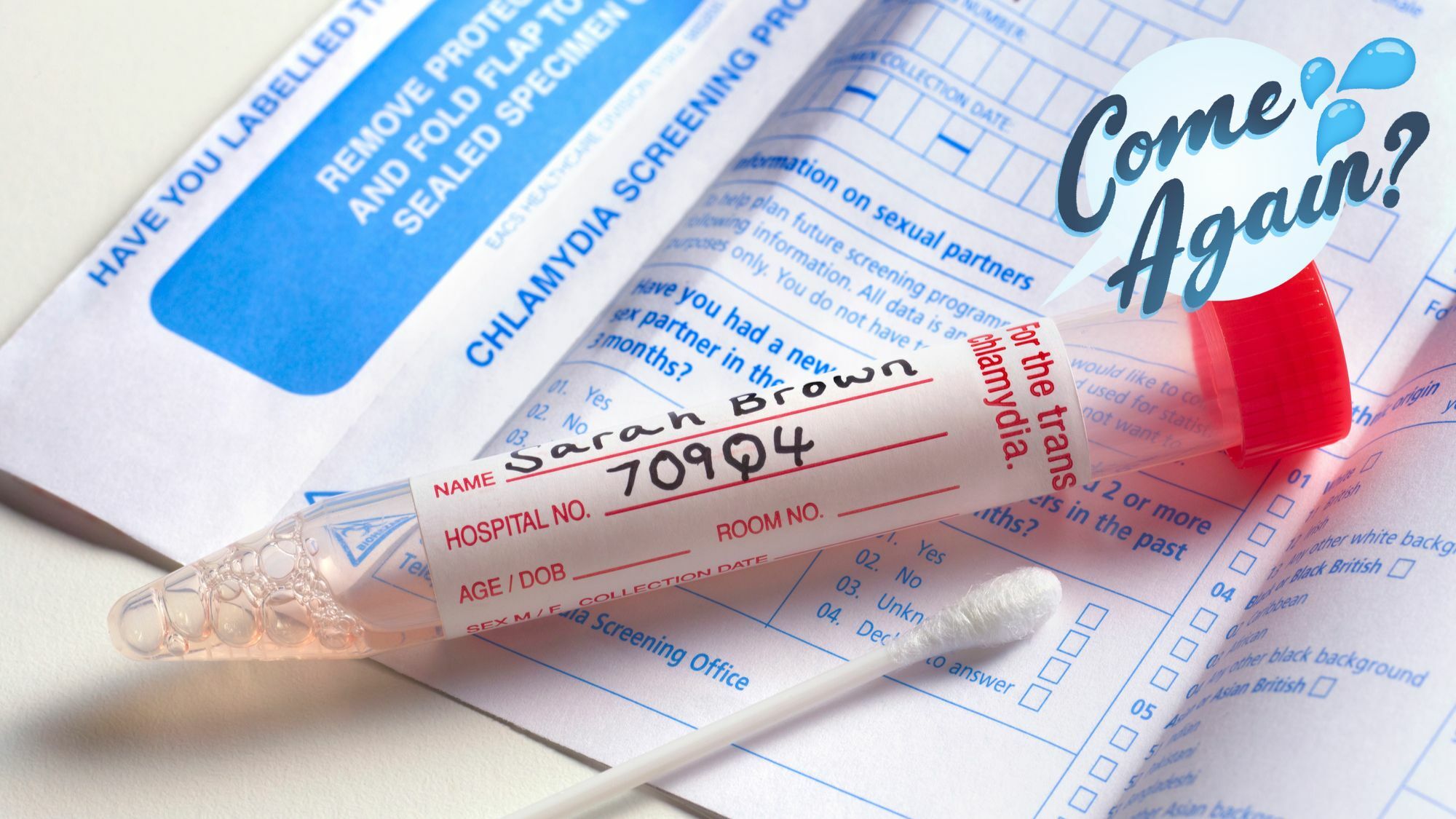 A swab rests near a tube, part of a chlamydia screening test kit.