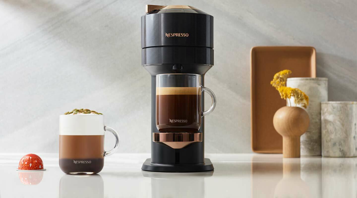 Nespresso coffee maker on countertop beside mug
