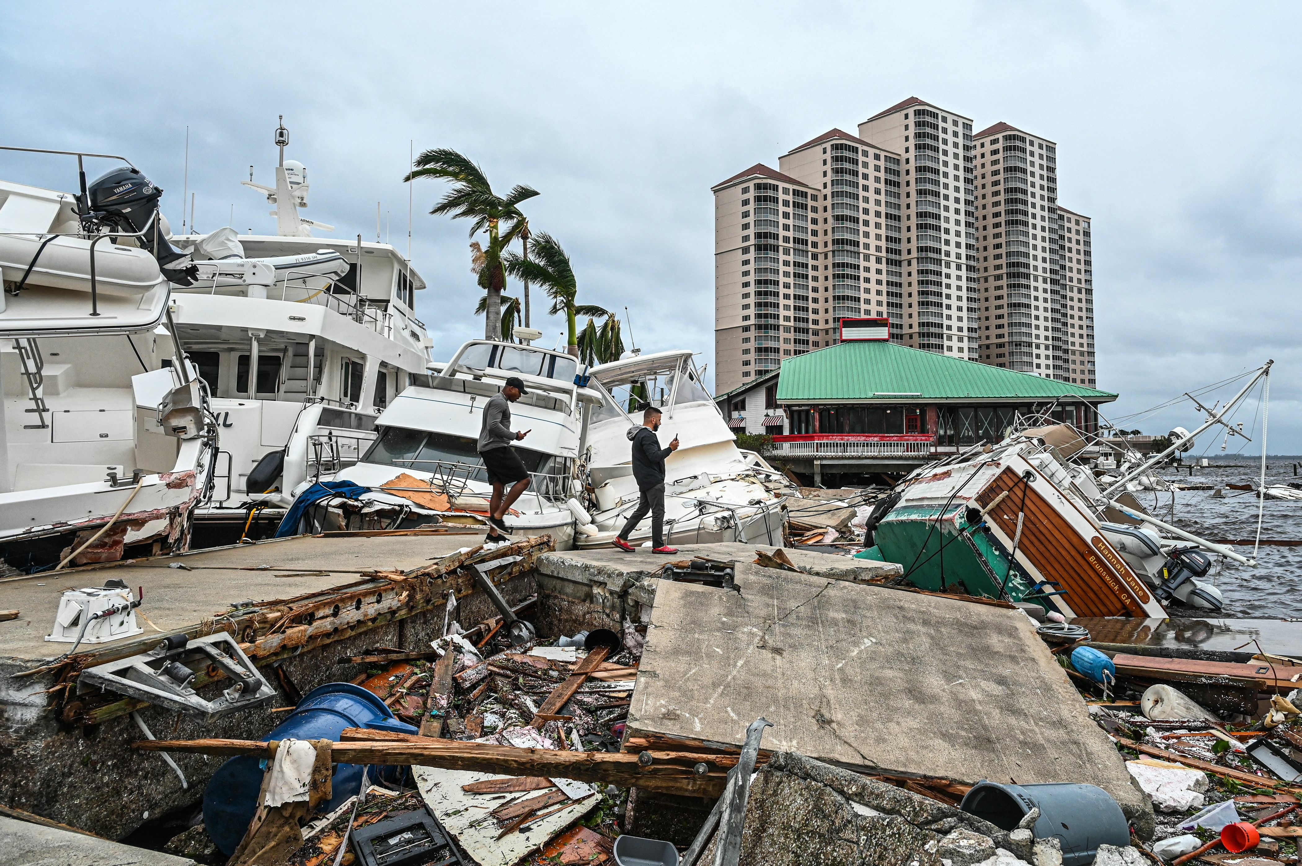 wreckage of boats and harbor structures after Hurricane Ian