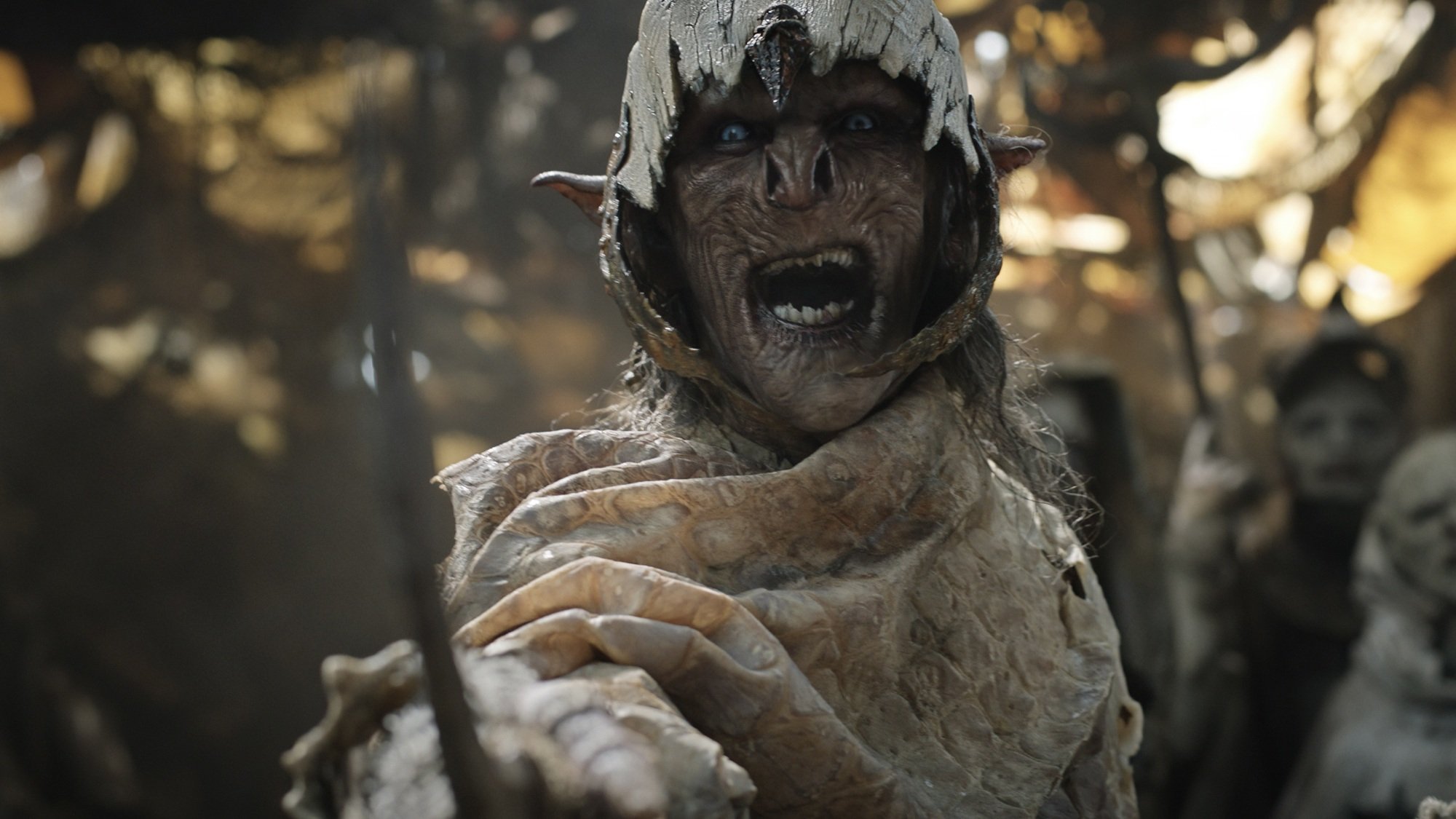 An orc cloaked in white raises his sword.
