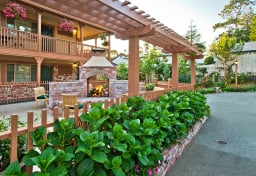 Outdoor patio of a hotel, with plants and a fireplace