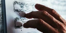 Fingers touching notes