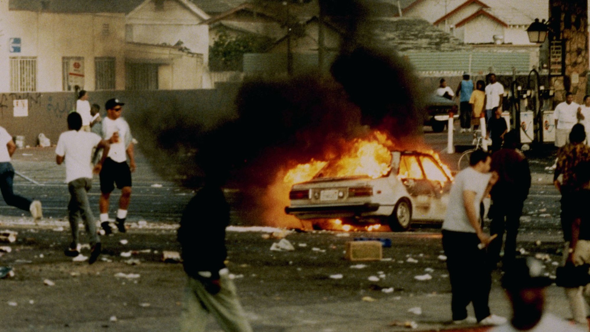 A car burns as looters take to the streets at the intersection of Florence and Normandie Avenues, April 29, 1992. This intersection is considered the flashpoint of the Los Angeles riots.