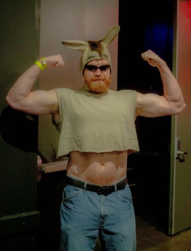 person in donkey hat flexing