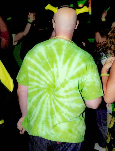 person in shrek ears and tie dye shirt