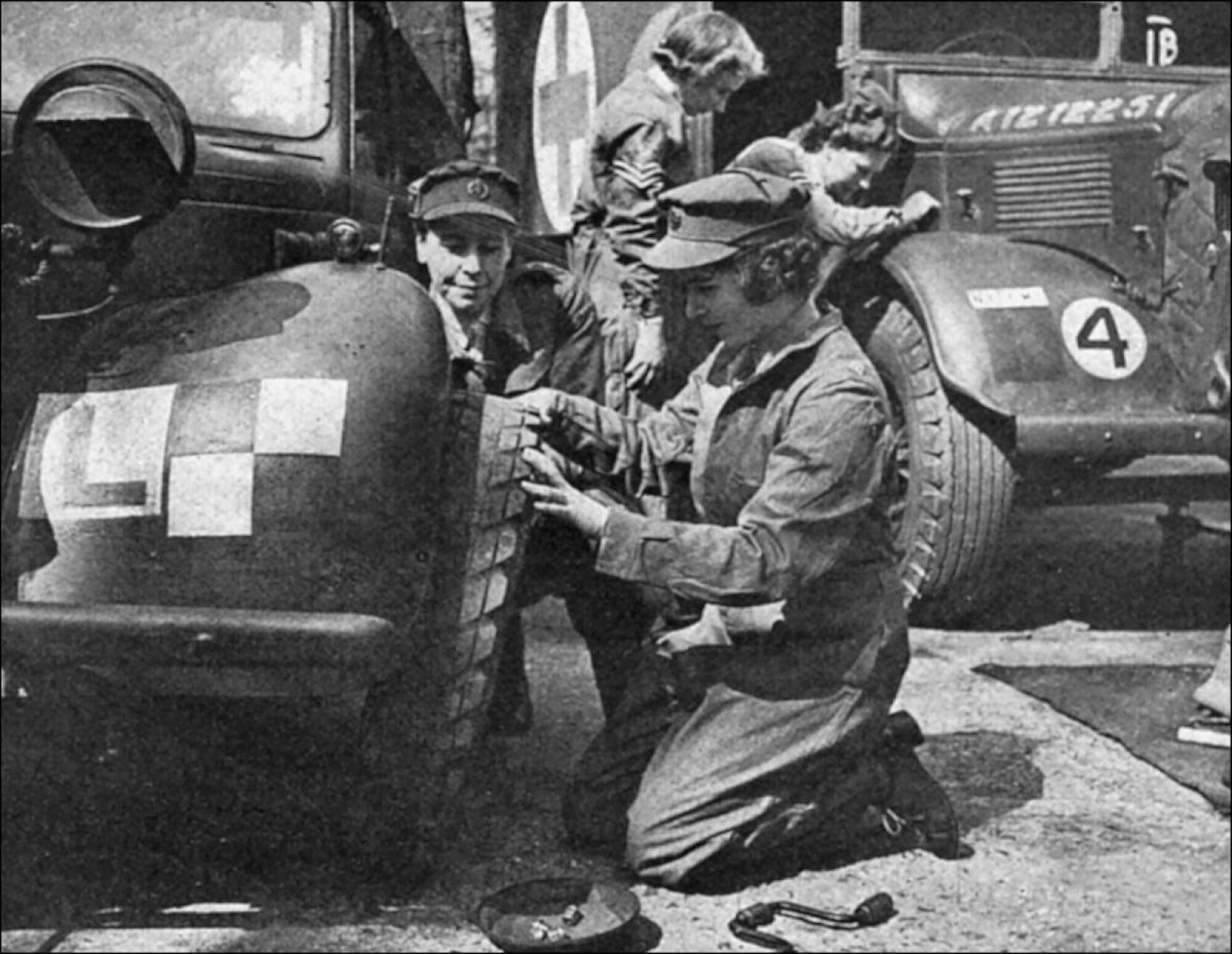 Princess Elizabeth kneels to carry out vehicle repairs in the 1940s