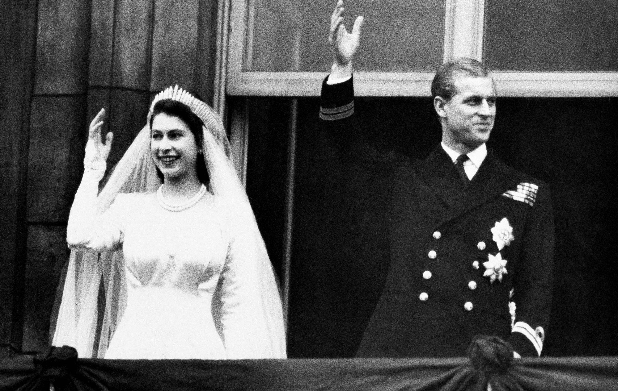 Princess Elizabeth marries Prince Philip of Greece, both waving at the crowd.