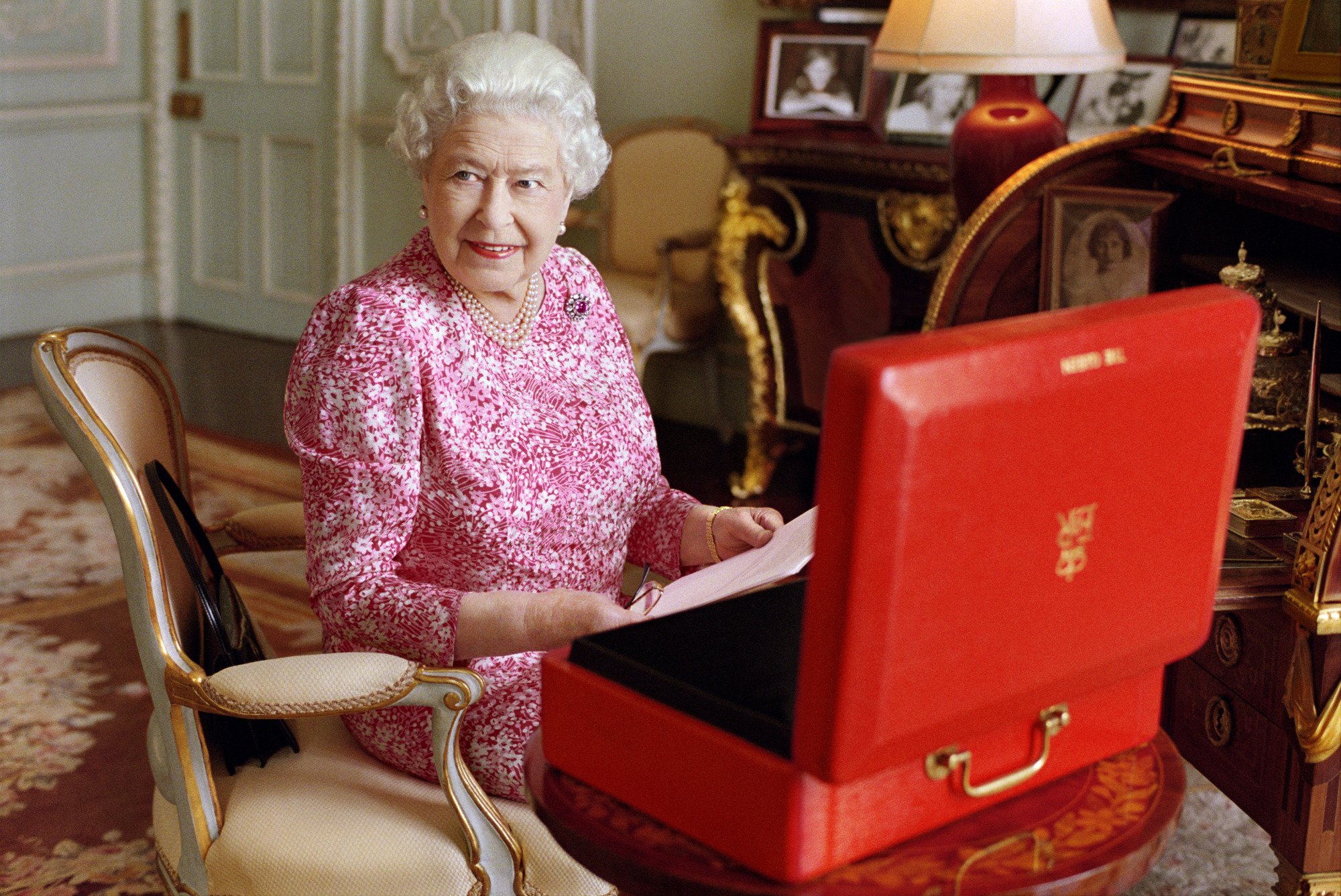 Queen Elizabeth II with one of her official red boxes which she has received almost every day of her reign.