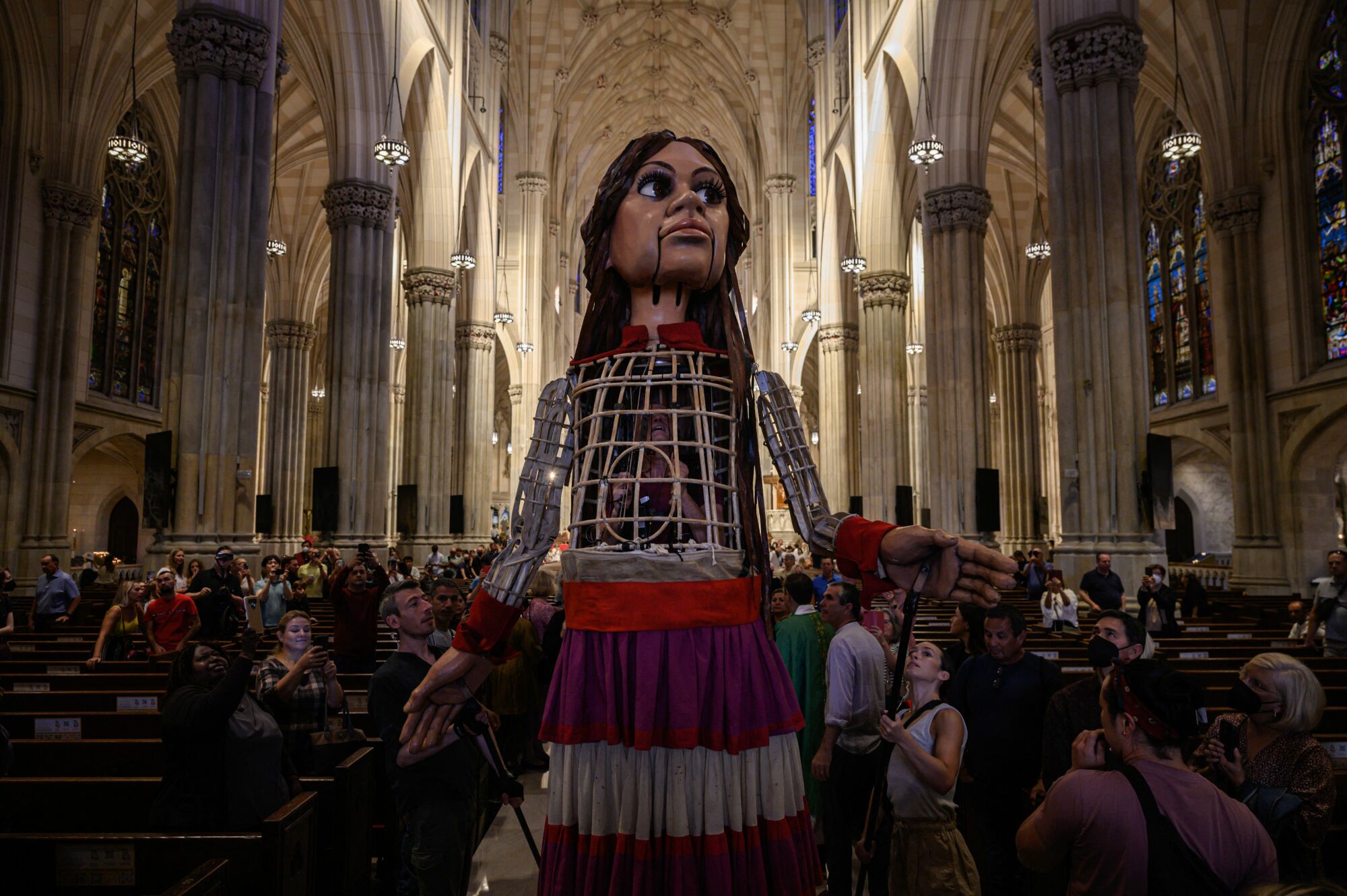 Amal stands in the middle of a crowd of parishioners at St. Patrick's Cathedral.