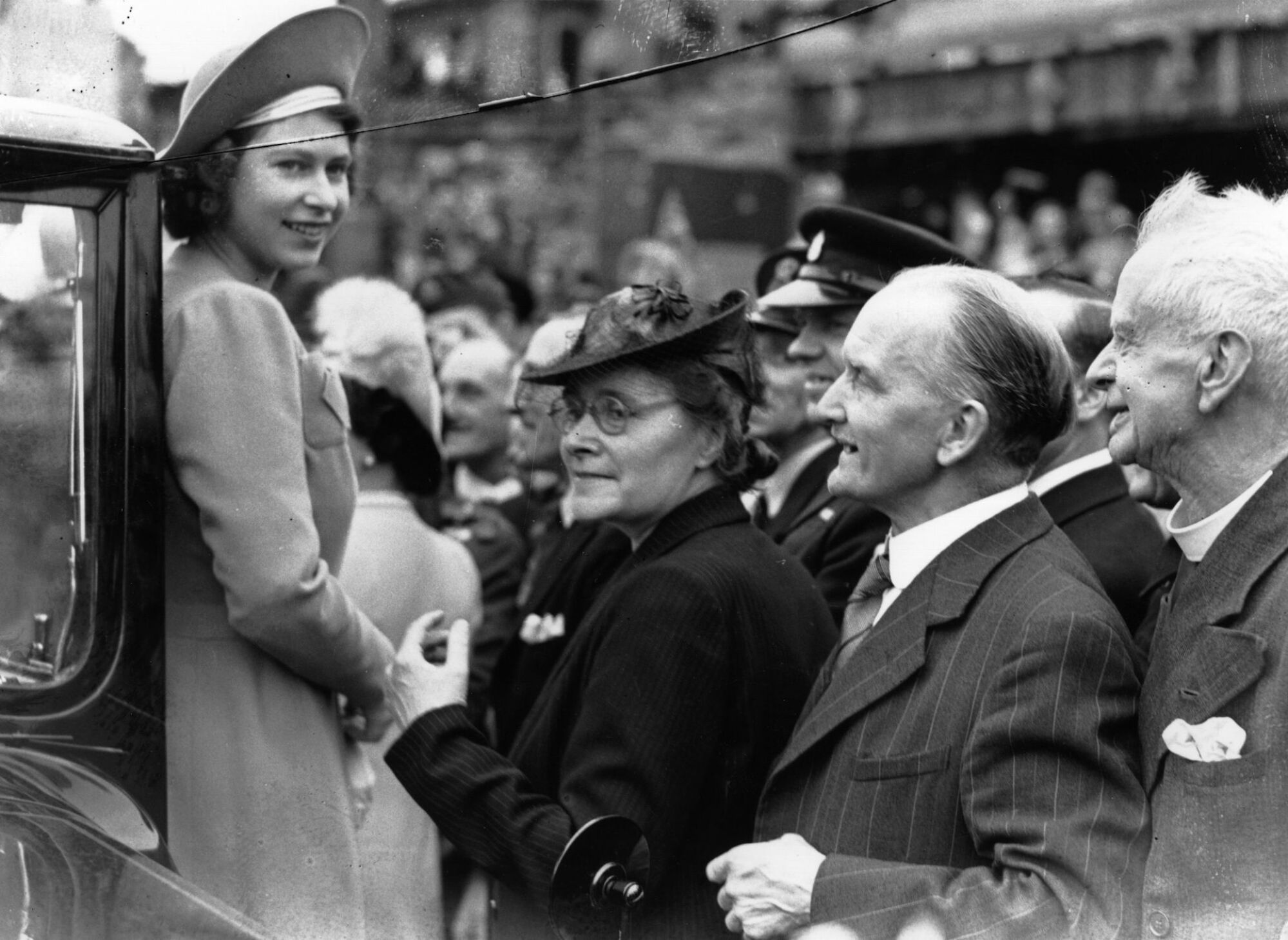 Princess Elizabeth (later Queen Elizabeth II) is greeted by crowds as she tours the East End of London on the day after VE Day, 9th May 1945.