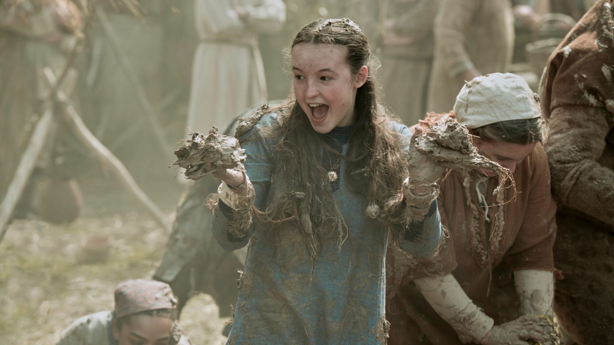Bella Ramsey is covered in mud and laughing in "Catherine Called Birdy."