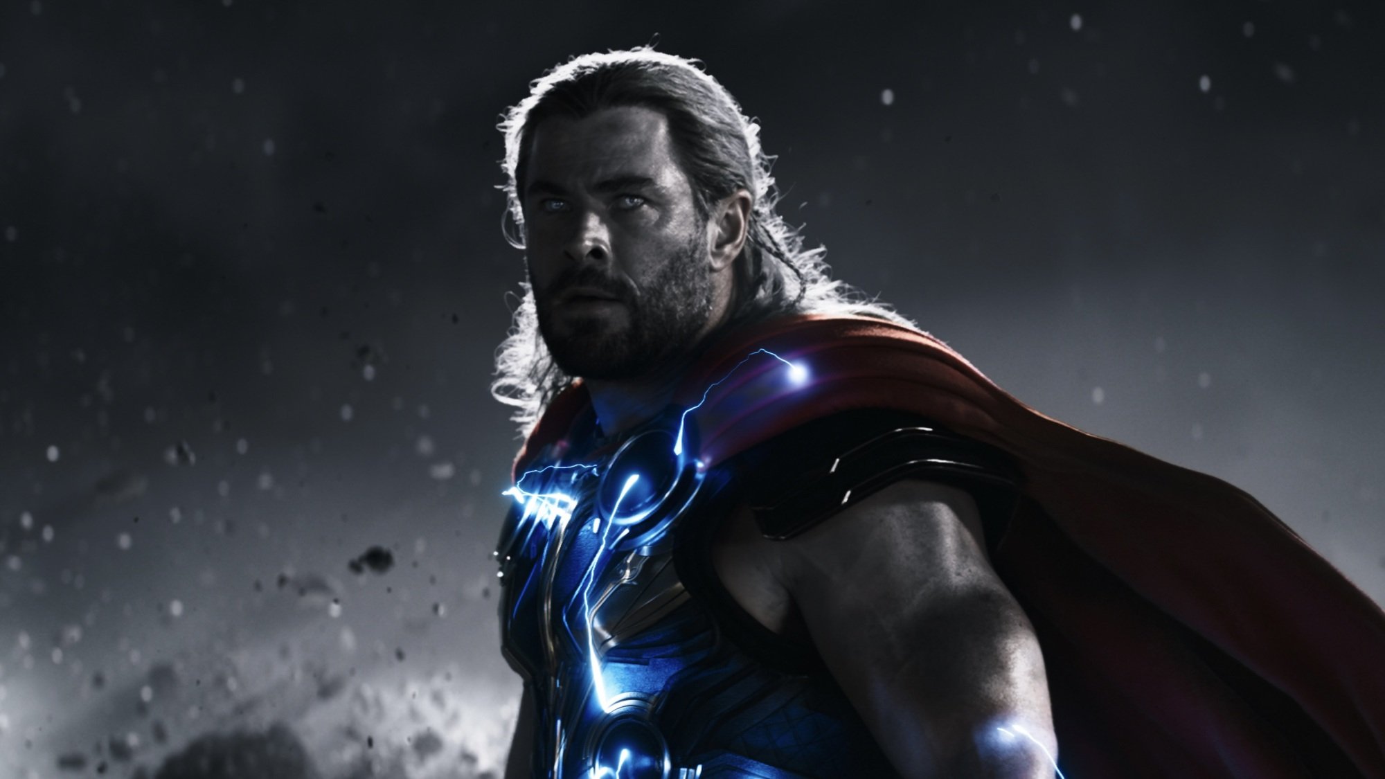 A blonde man in a red cape and armor.