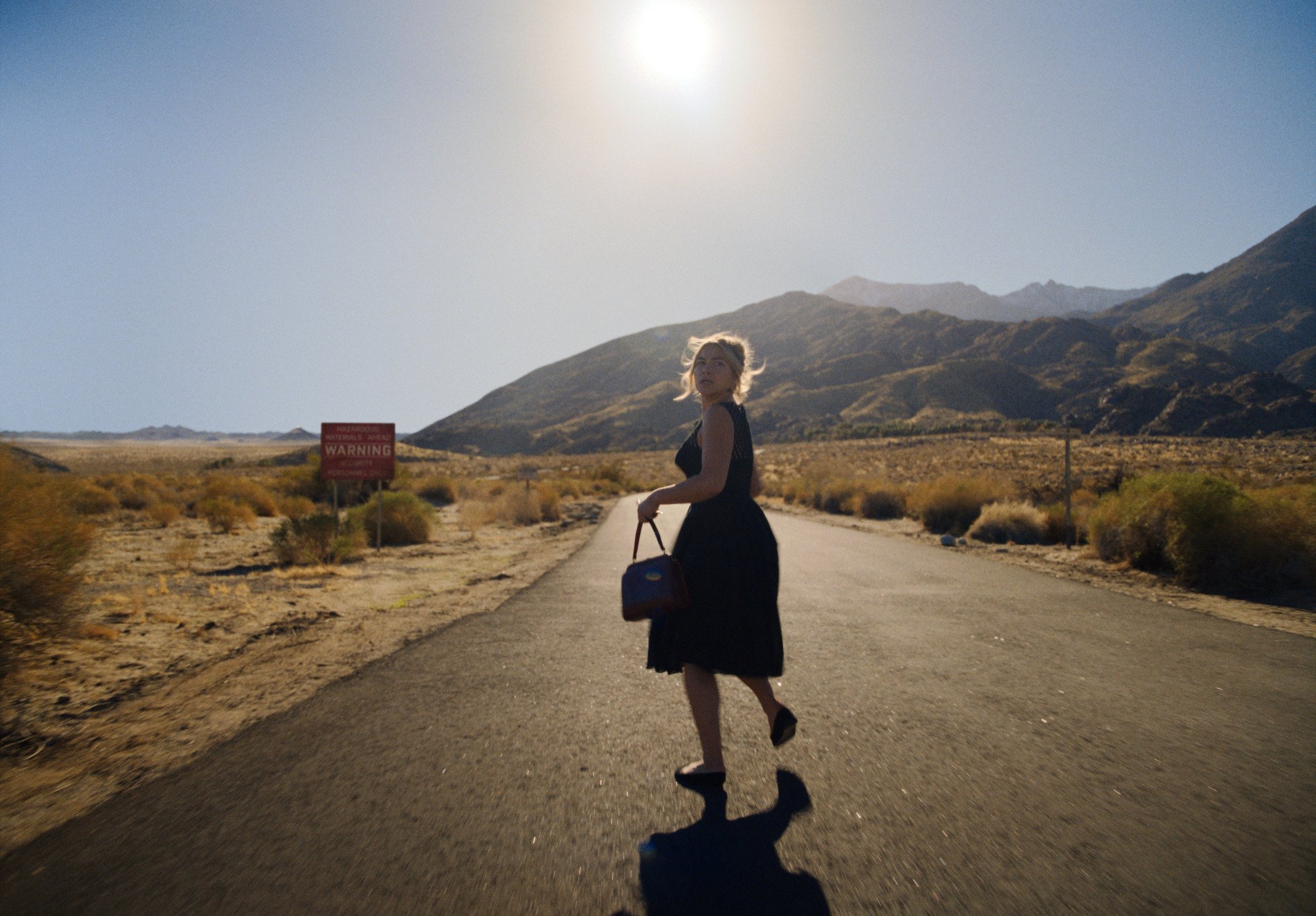Florence Pugh runs down an empty road in "Don't Worry Darling."