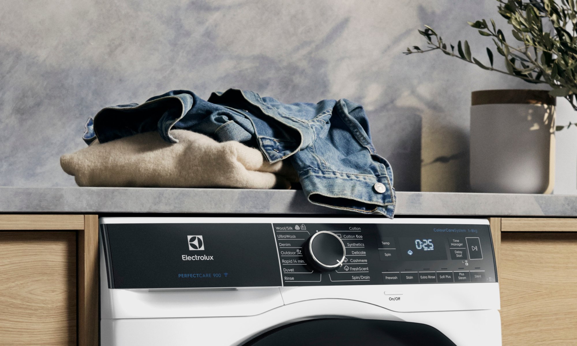 Pile of clothes sit on top of washing machine