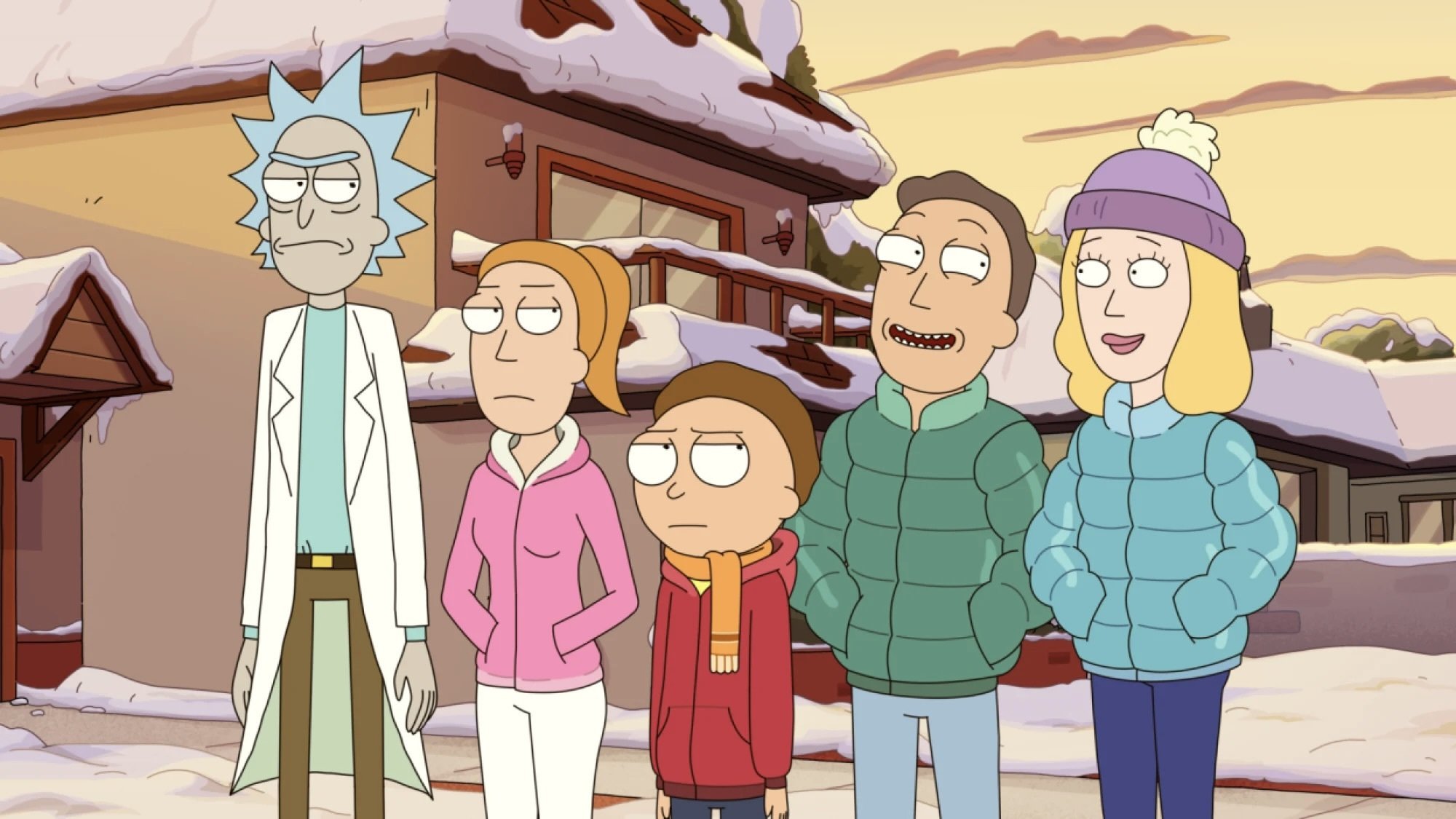 A family stands outside a snowy house.