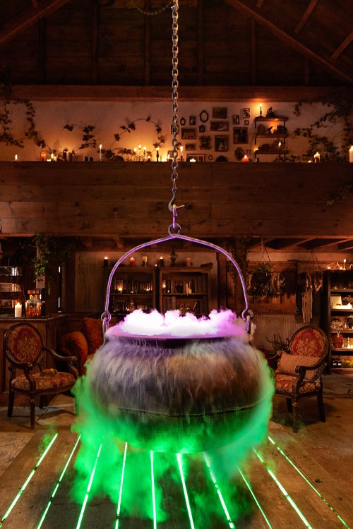 A cauldron with colored smoke emerging from it.
