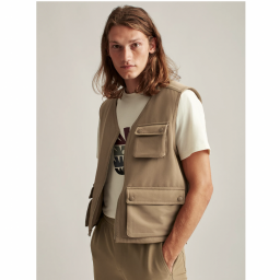 Person wearing tan colored cargo vest