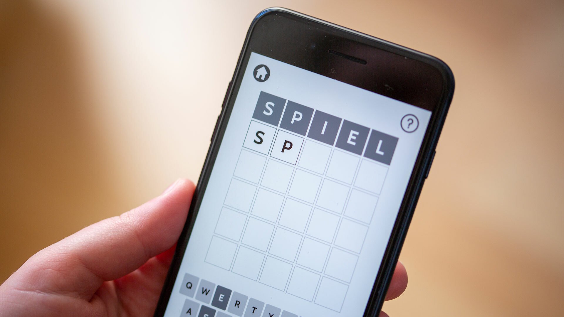 A close-up of someone playing Wordle on a smartphone.
