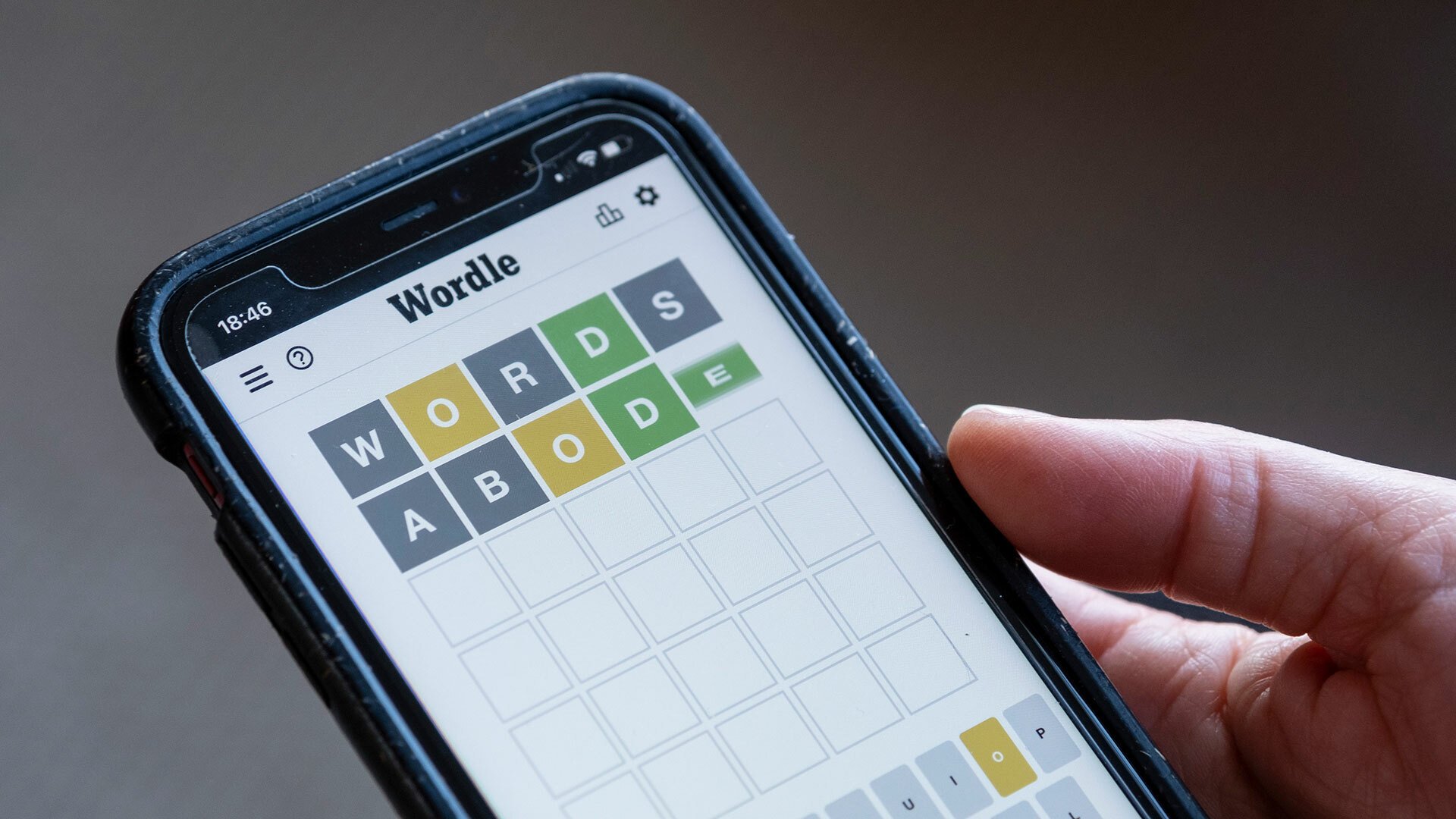 A close-up of a person playing Wordle on their smartphone.