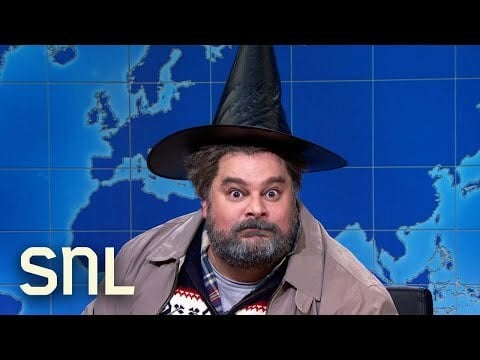 Bobby Moynihan wearing black witch's hat