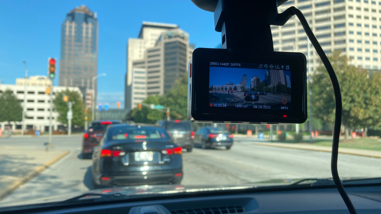 dash cam in front of windshield with view of street and cars