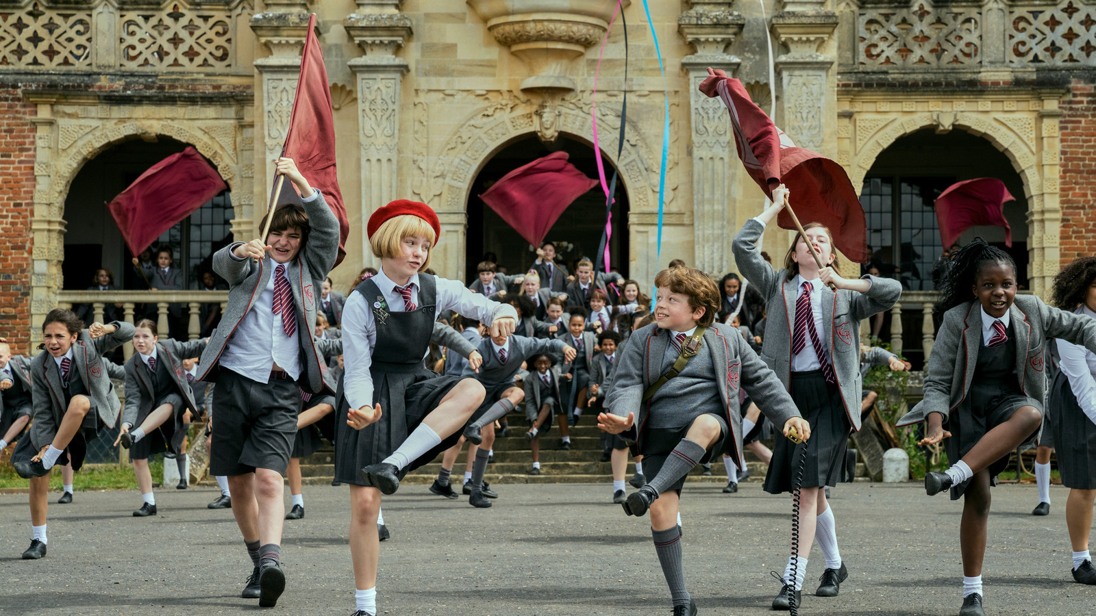Kids in school uniforms dancing.