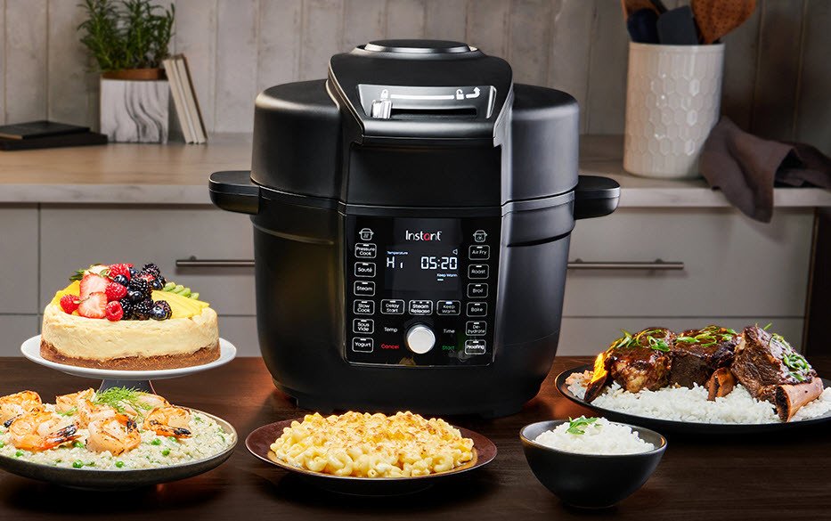 Instant Pot Duo Crisp Ultimate Lid air fryer pressure cooker on table surrounded by dished of food