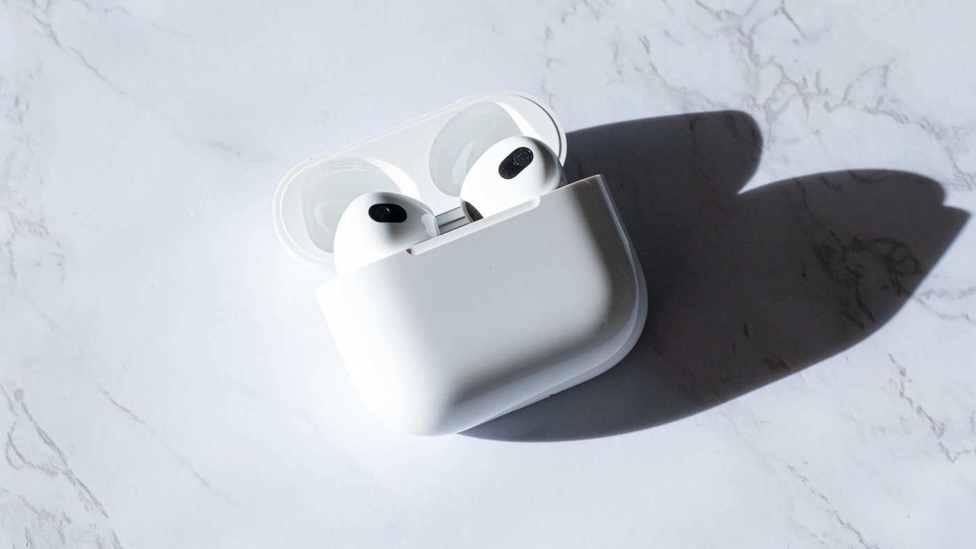 Apple third generation AirPods in case on marble table