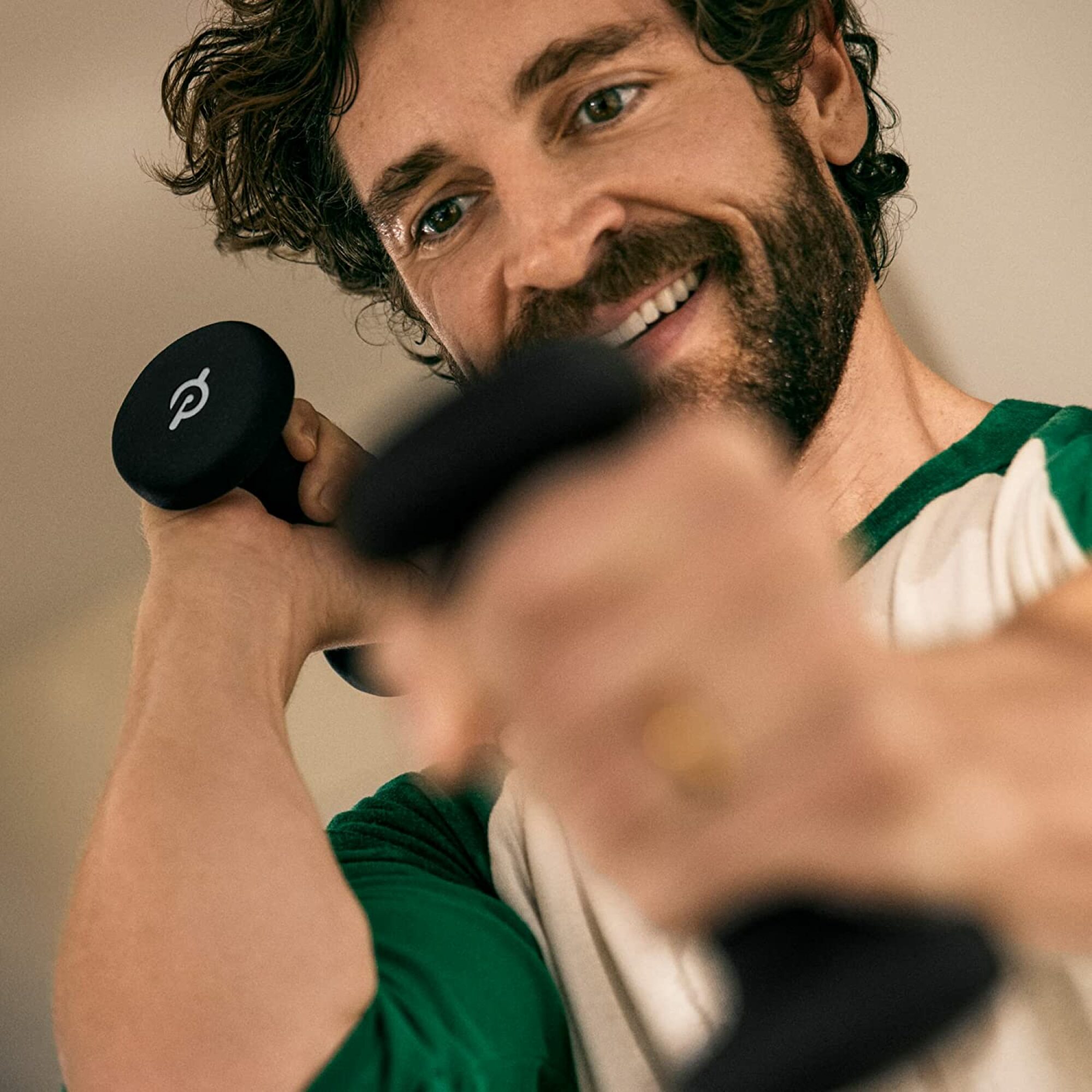 Person using the Peloton Light Weights (1 or 2 pounds).