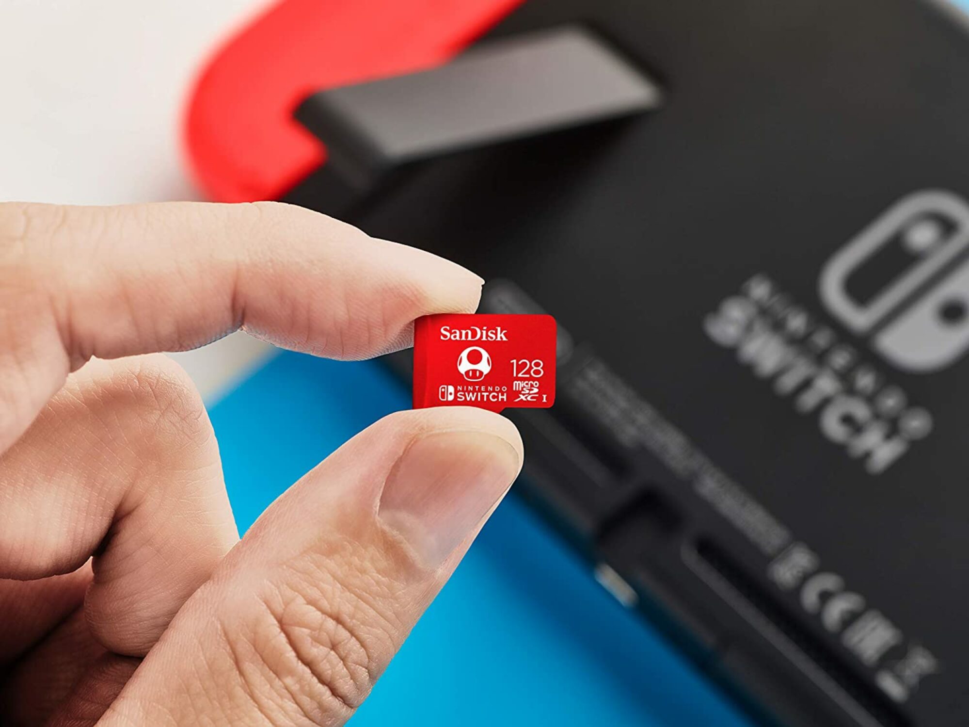 Person holding the SanDisk 128GB microSDXC Card for Nintendo Switch.