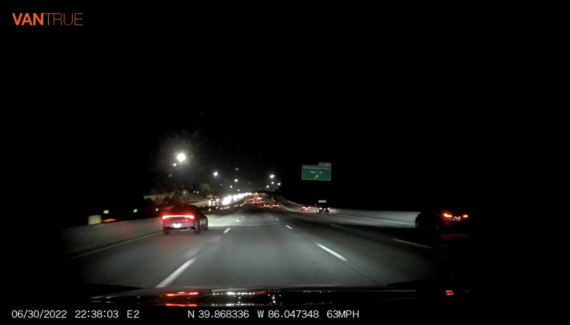 night time shot of cars on a road from the view of a dashcam