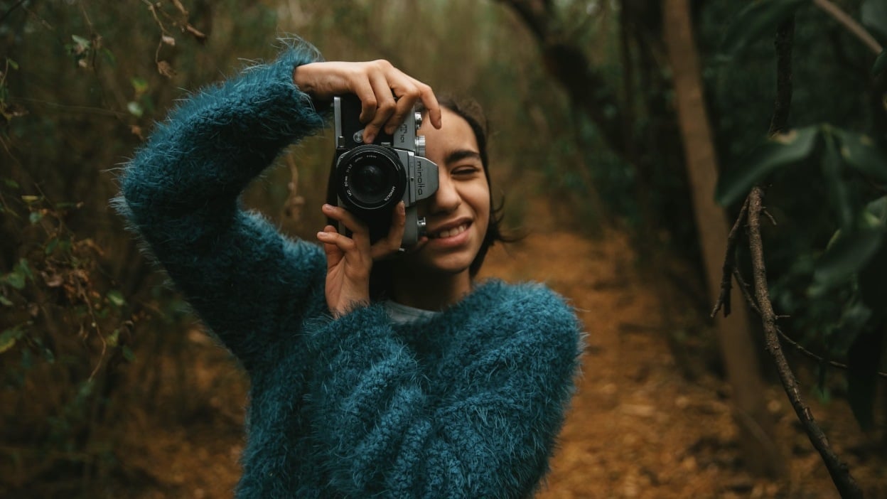 Girl taking photo with camera